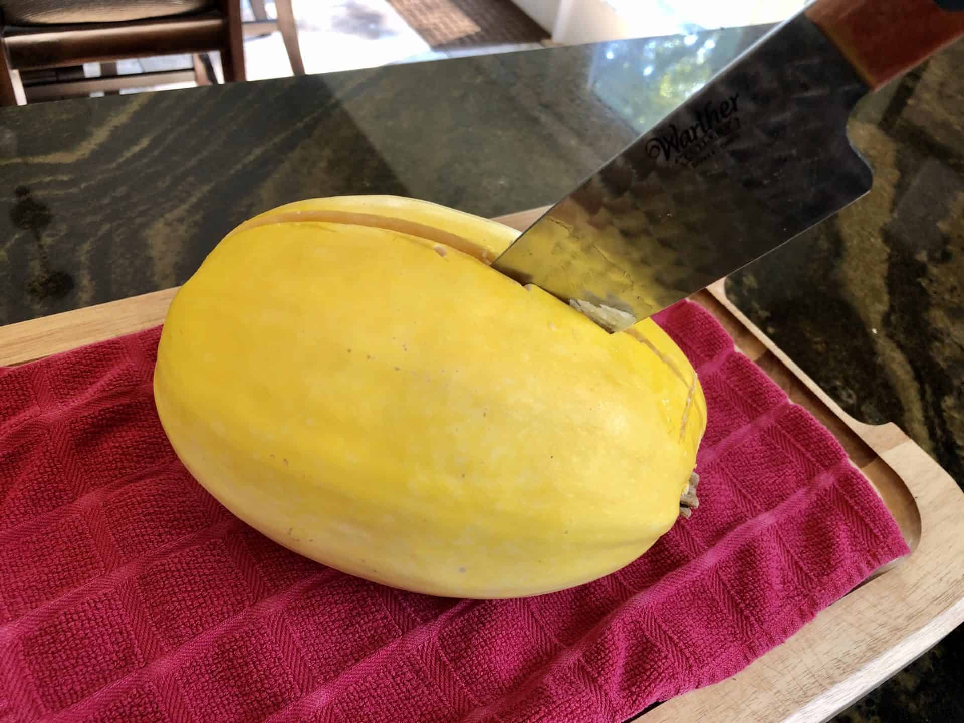 Spaghetti Squash being sliced in half from other direction 