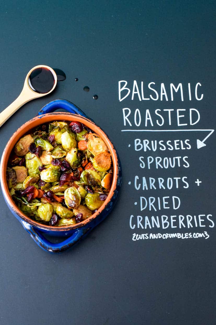 Balsamic roasted Brussels sprouts in blue bowl with chalkboard writing explanation of ingredients
