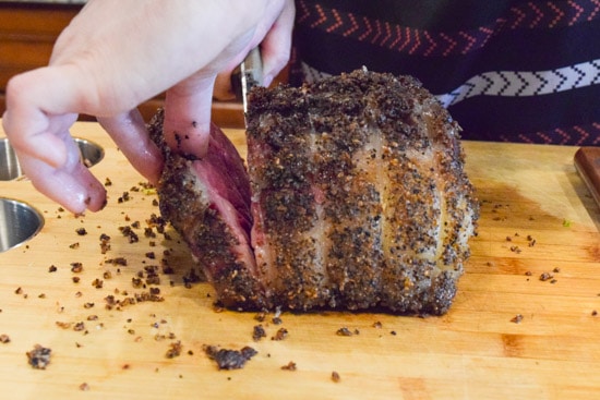 smoked prime rib actively being sliced side view