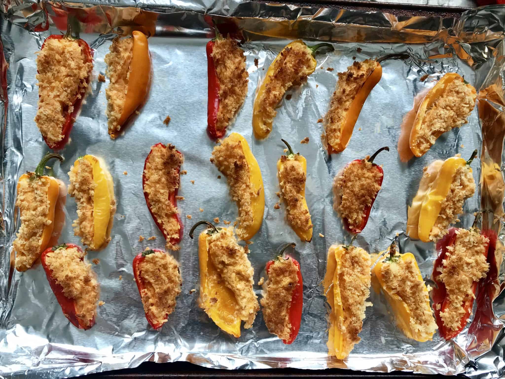 Mini peppers topped with bread crumbs baked overhead shot