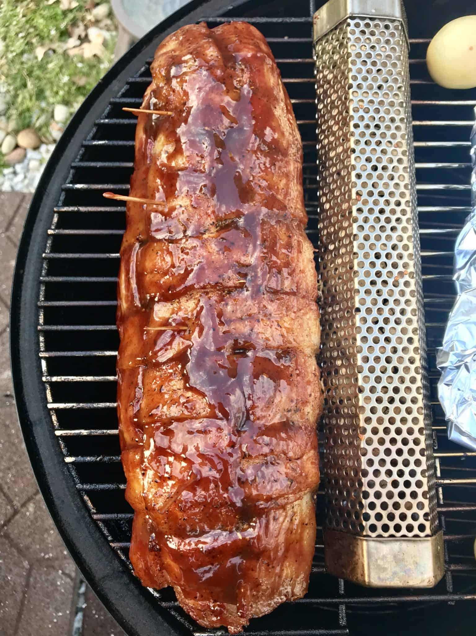 Bacon explosion sauced on weber grill overhead shot