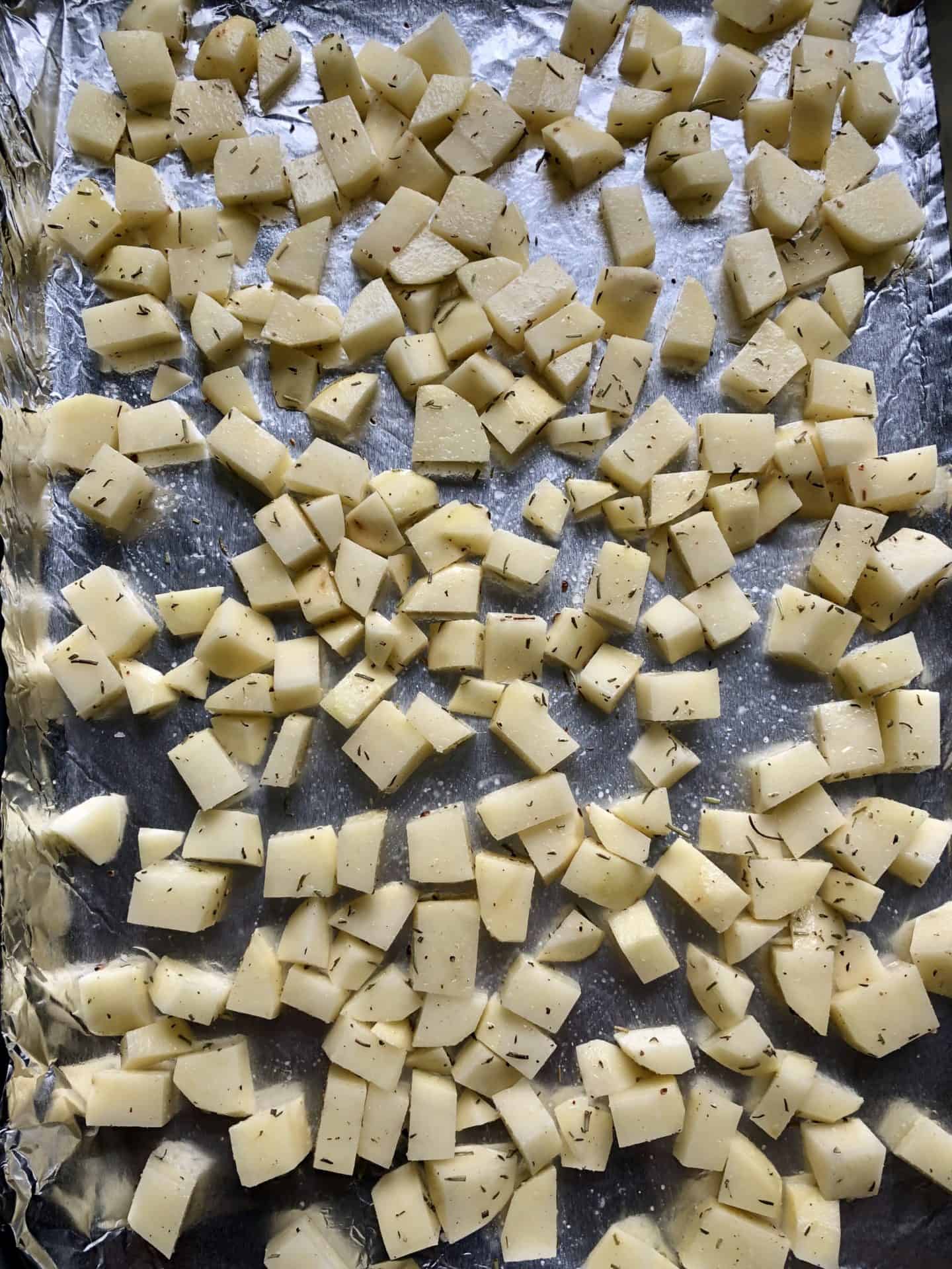 diced potatoes uncooked on baking sheet