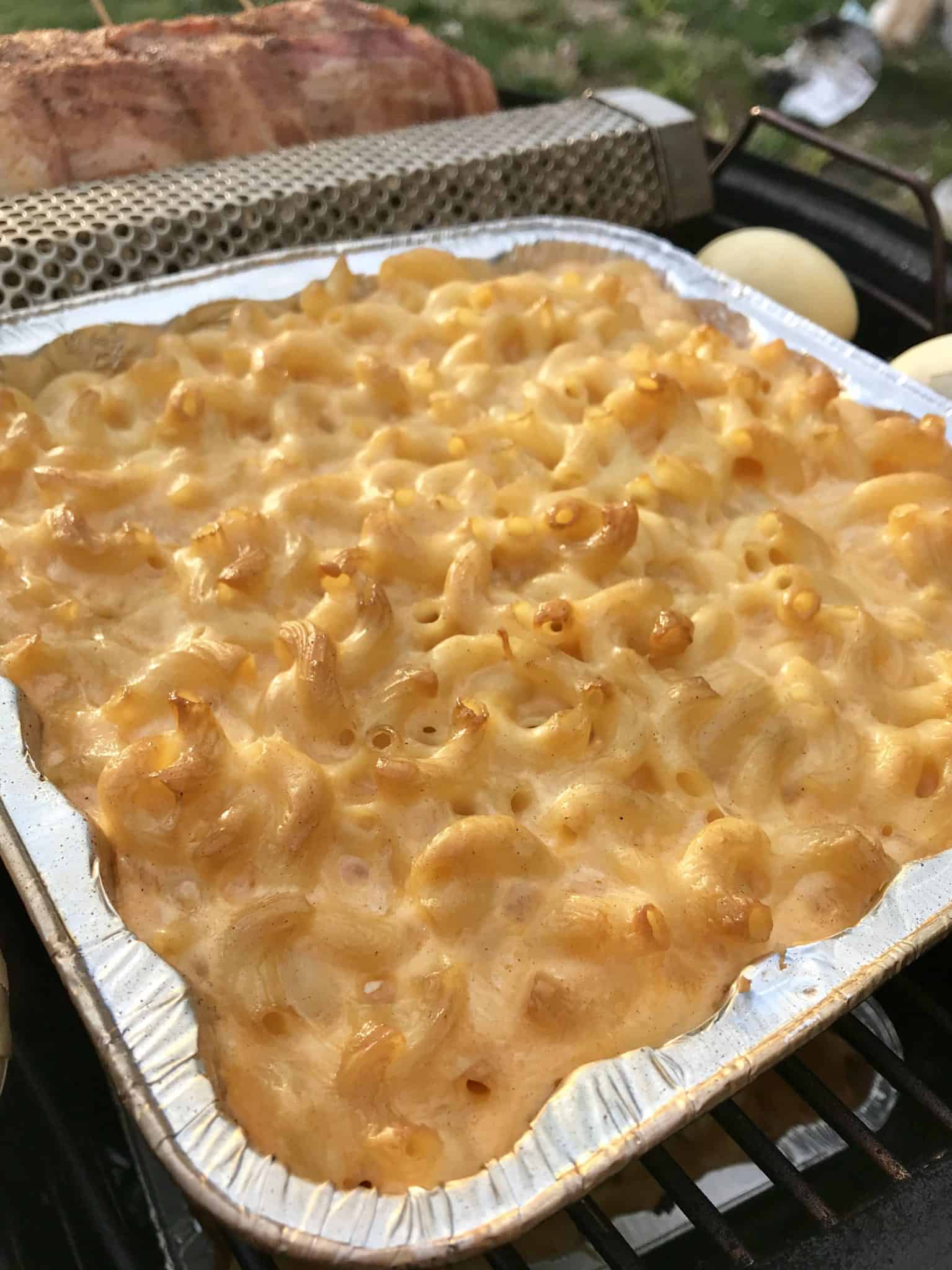 close up view of Smoked Mac and cheese in foil pan on smoker 