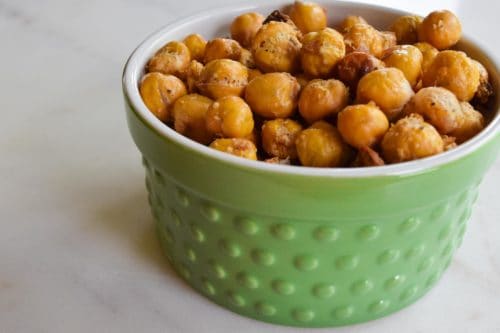 garlic and parmesan roasted chickpeas in green bowl close up view