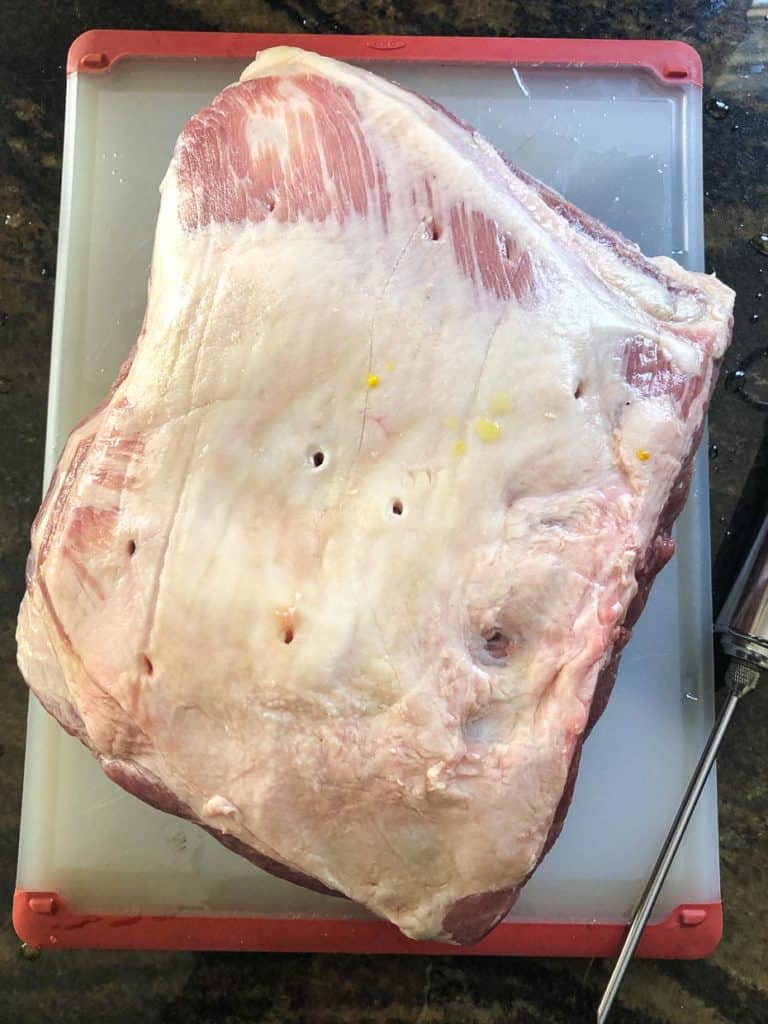 Pork butt on cutting board overhead shot