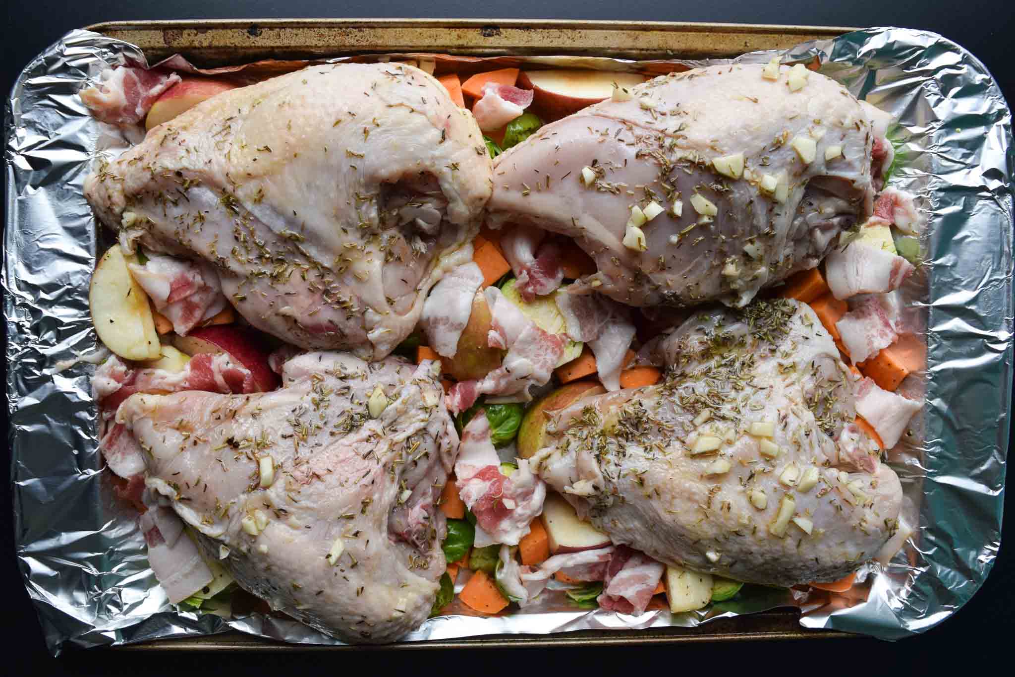 one pan harvest chicken ingredients on baking sheet ready to be cooked
