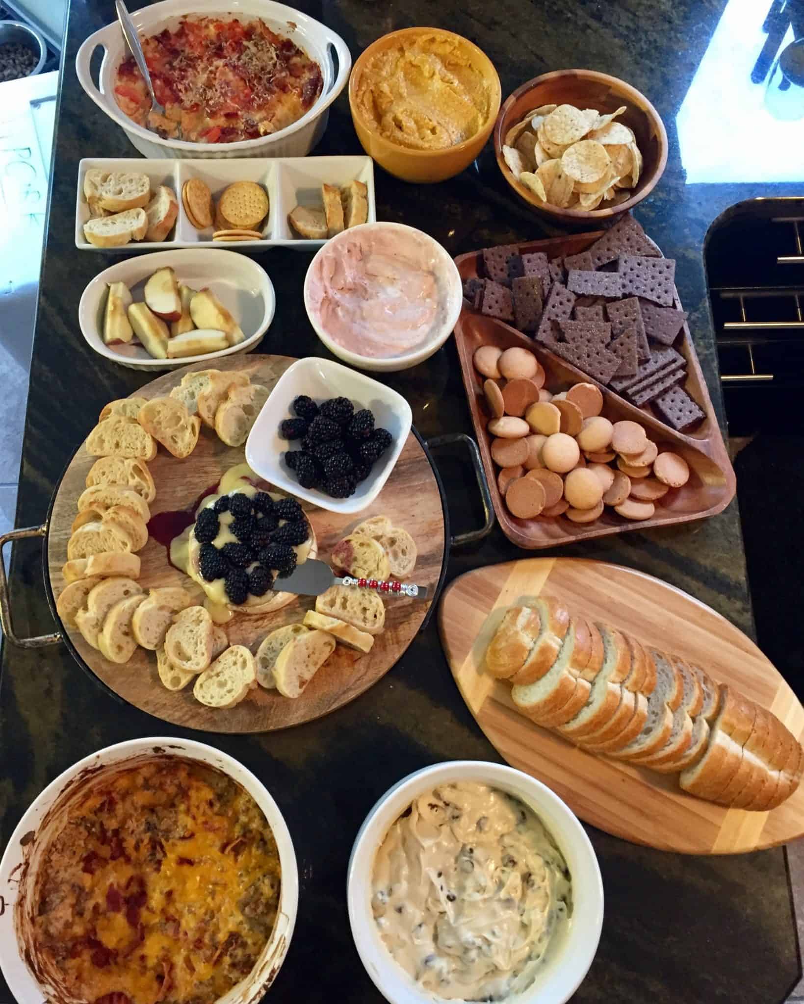 Spread of dips bread and crackers overhead shot