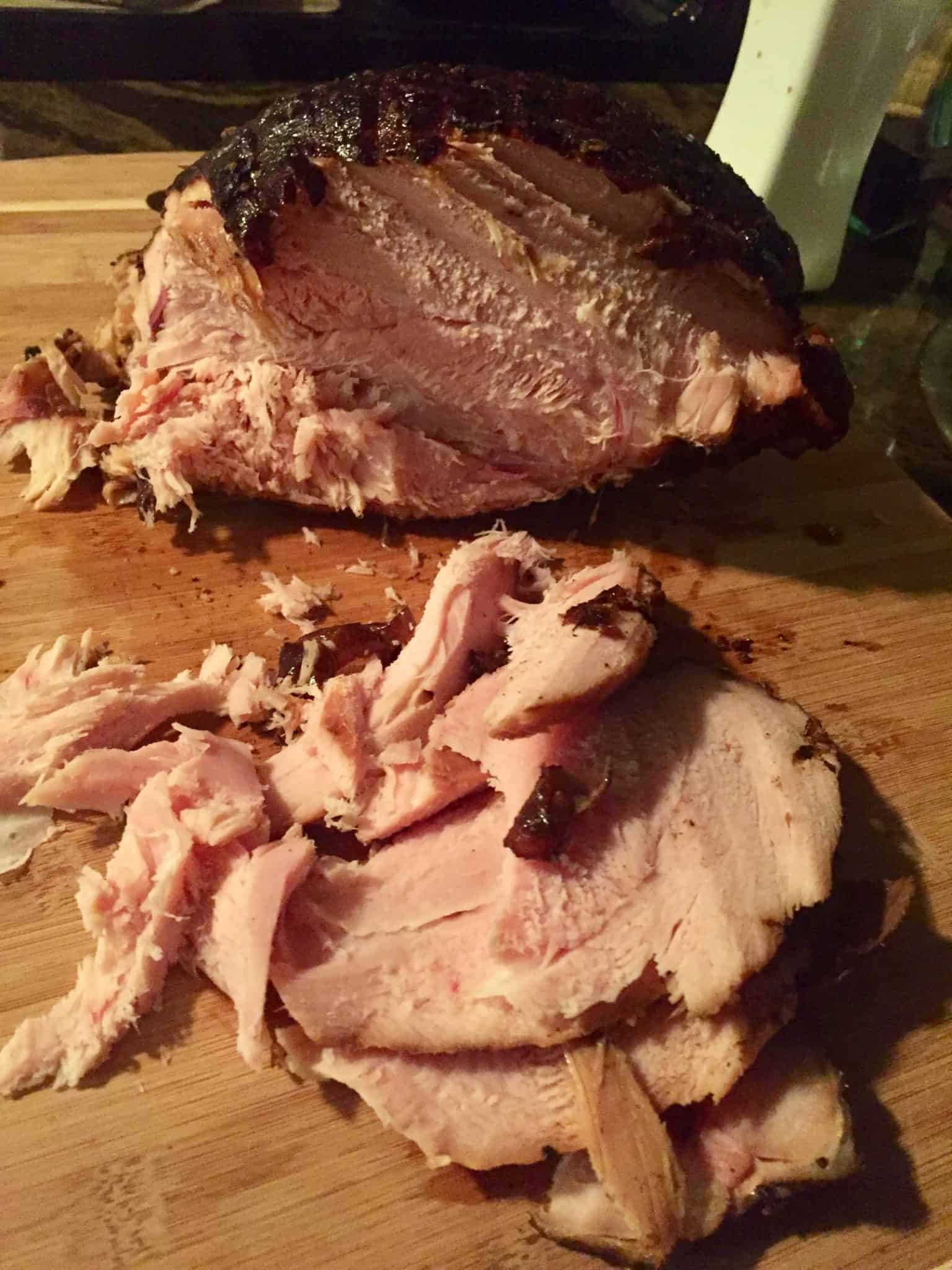 easy double smoked turkey sliced on wooden cutting board up close view
