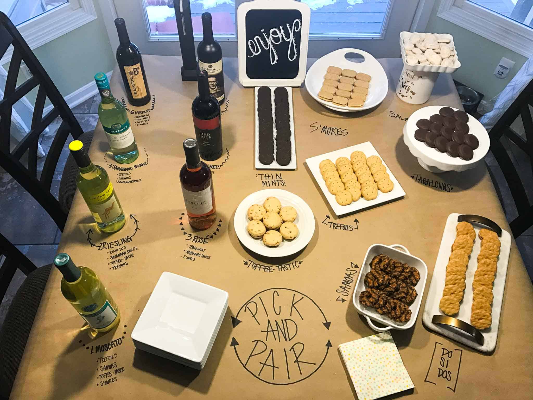 girl scout cookie and wine pairing set up on kitchen table overhead shot