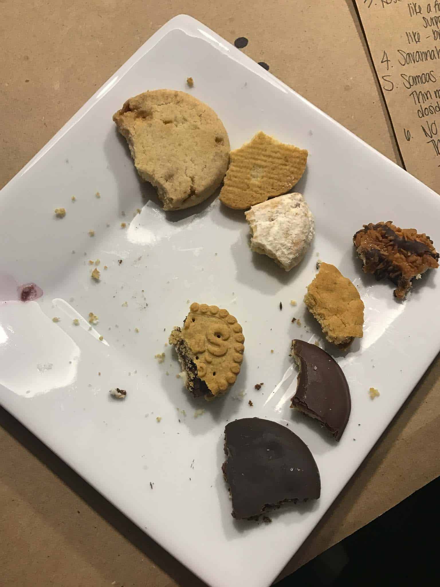 plate of Girl Scout cookies with small bites taken out of each one
