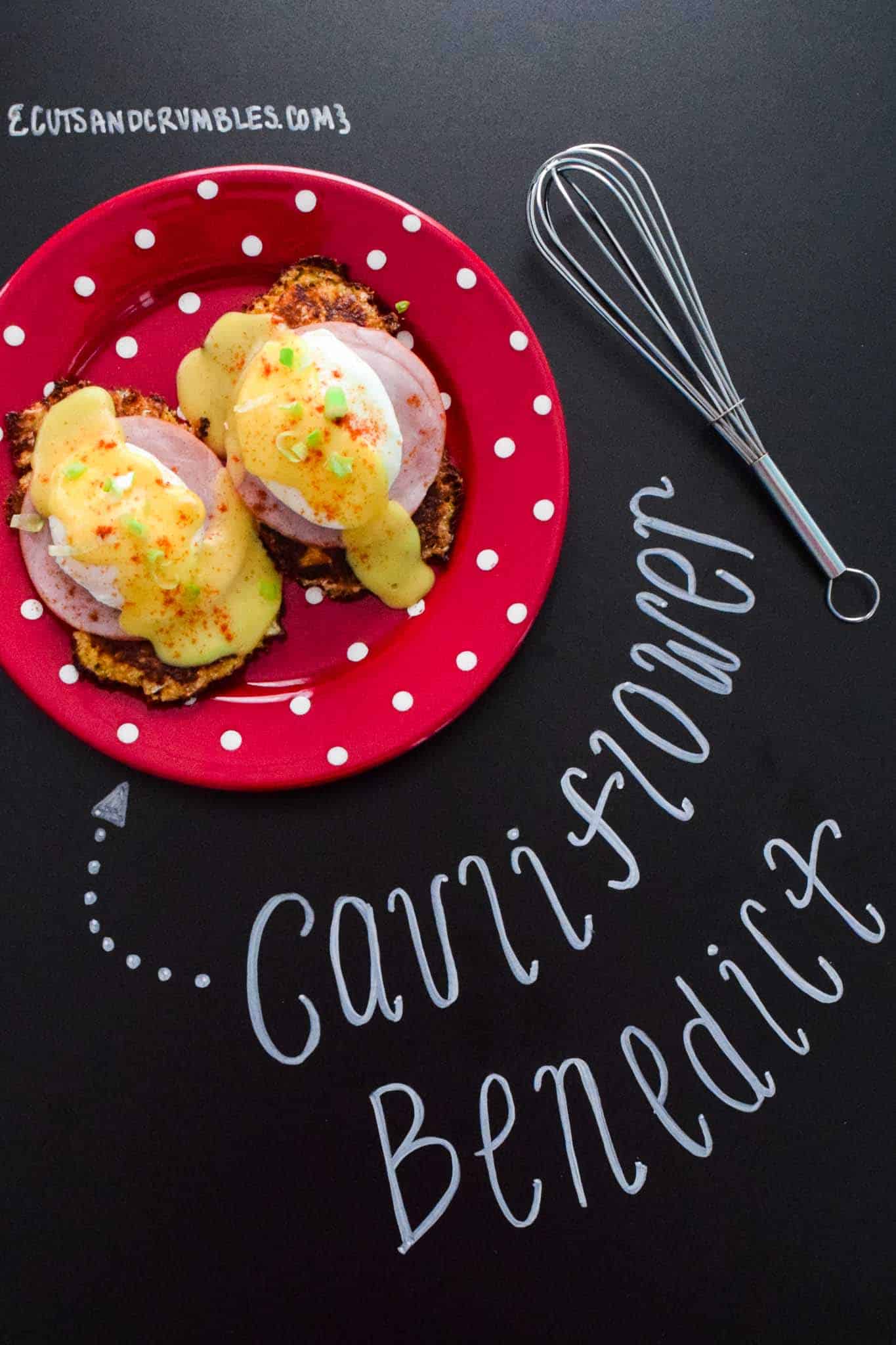 cauliflower benedict on red plate with title written on chalkboard