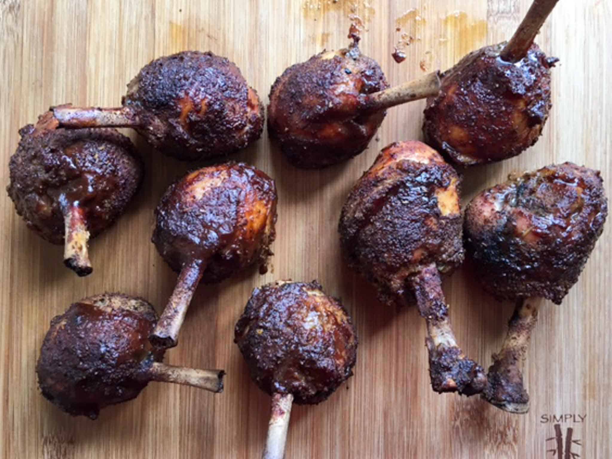 Chicken Lollipops smoked on wooden cutting board overhead shot