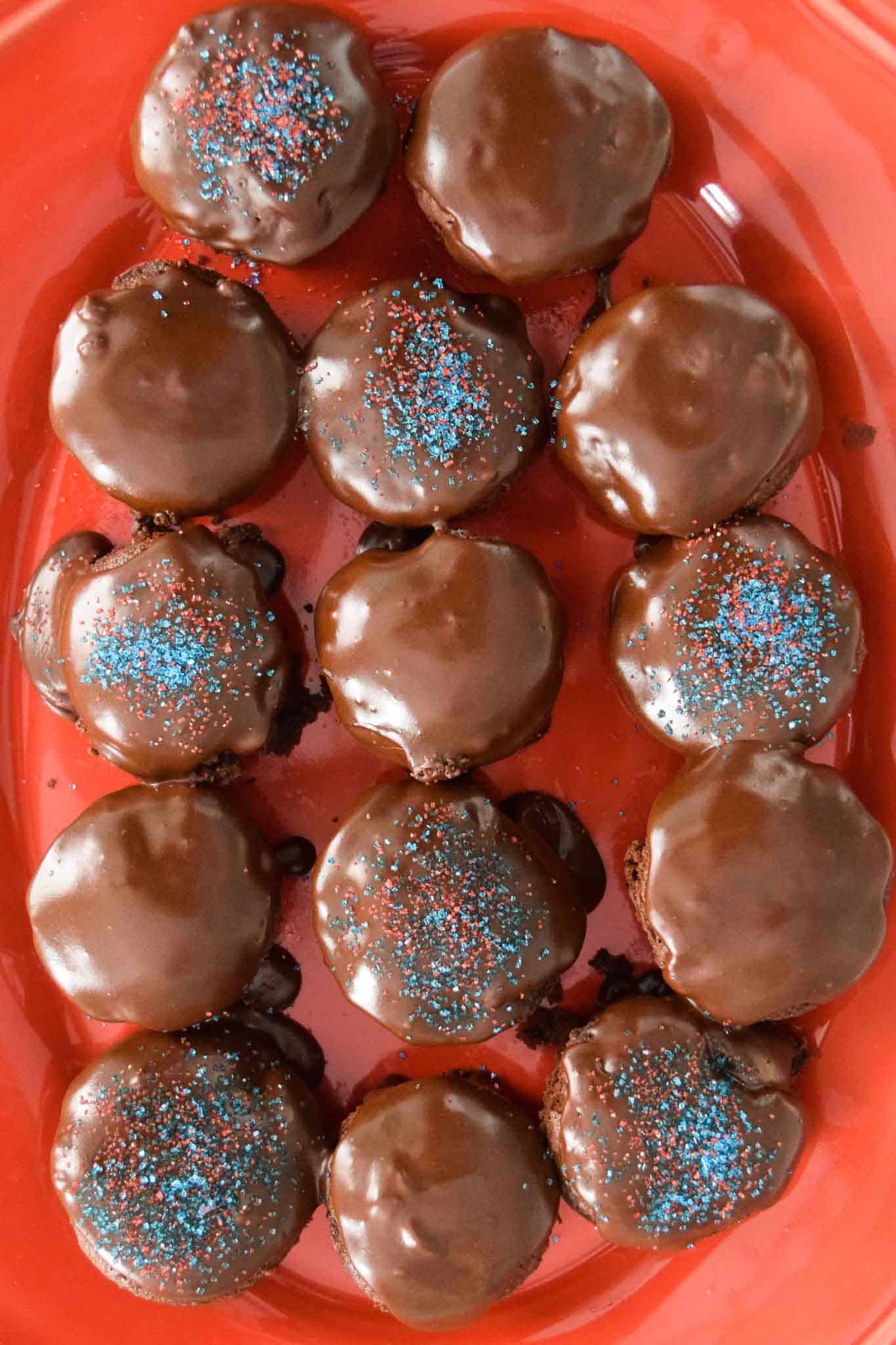 Chocolate Chip Brownie Bites with Homemade Icing on red platter overhead shot