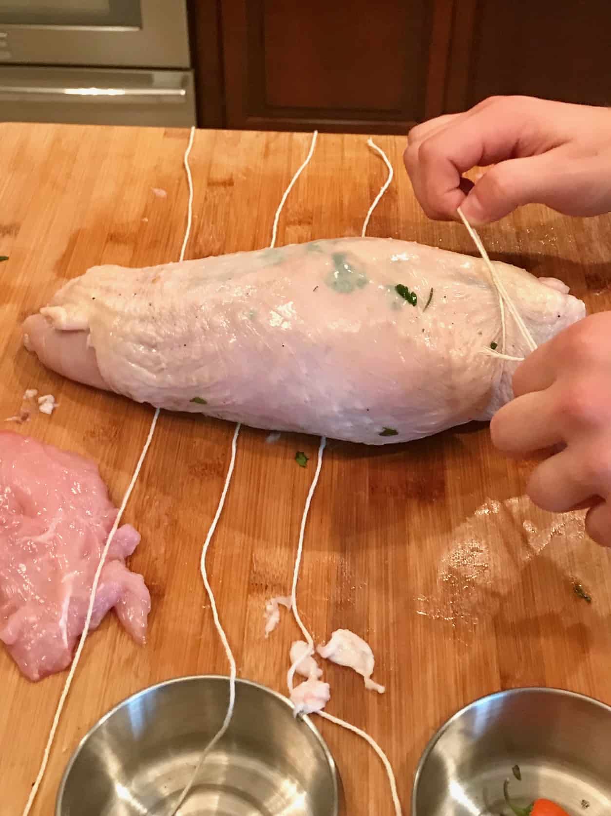 Turkey Porchetta being wrapped in twine side view