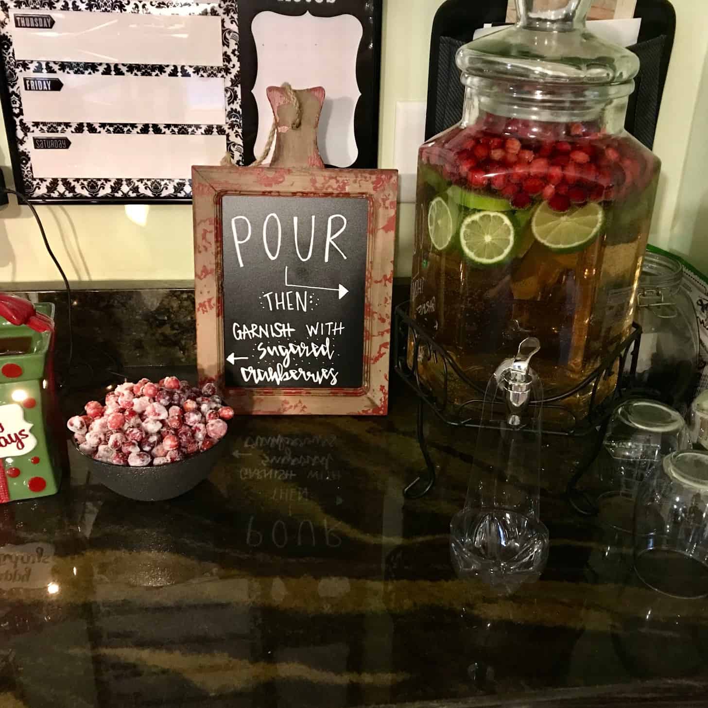 Holiday Sangria in drink dispenser with sugared cranberries