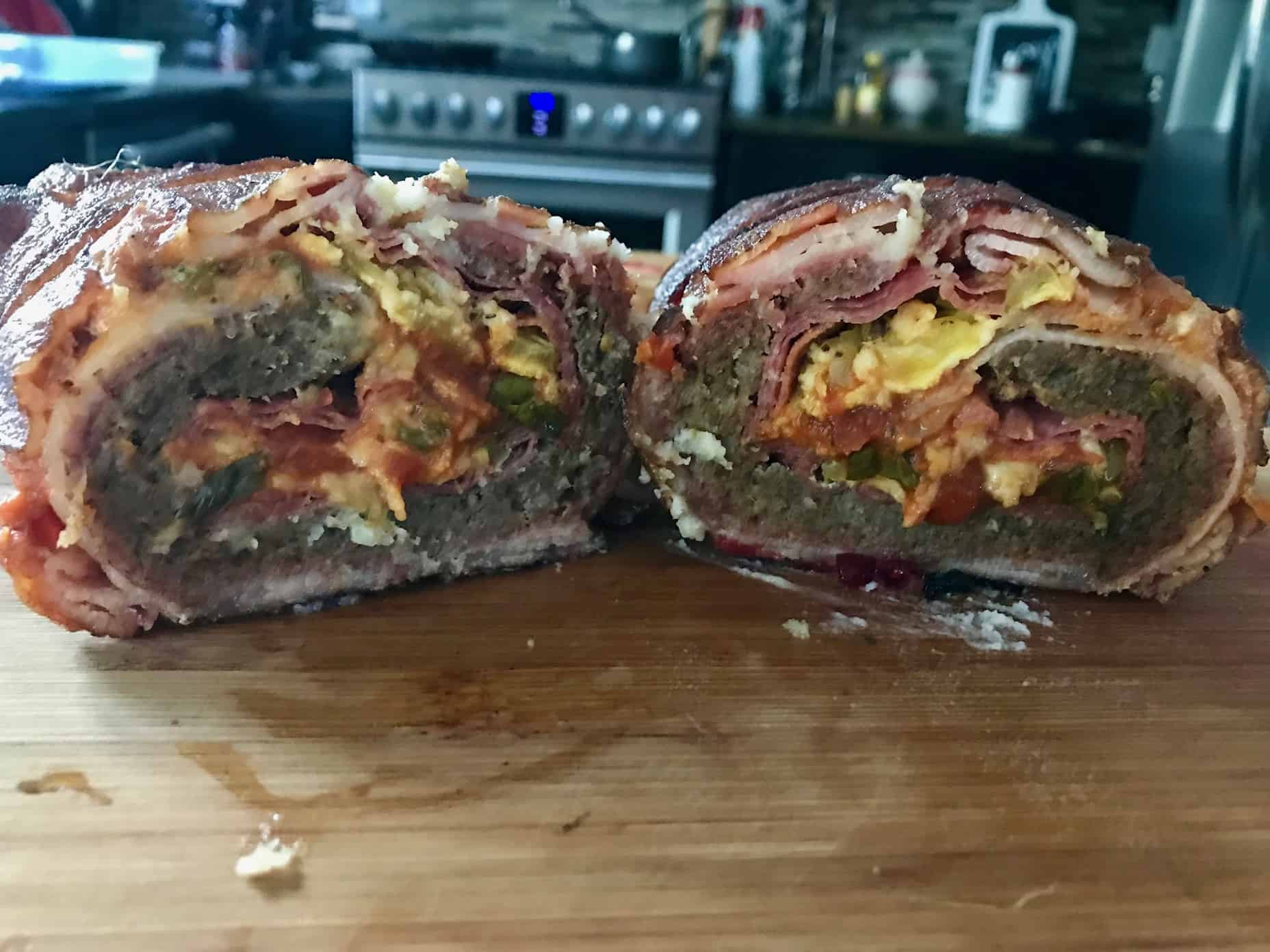 Pizza Bacon Explosion sliced in half to see pizza ingredients in side close up view