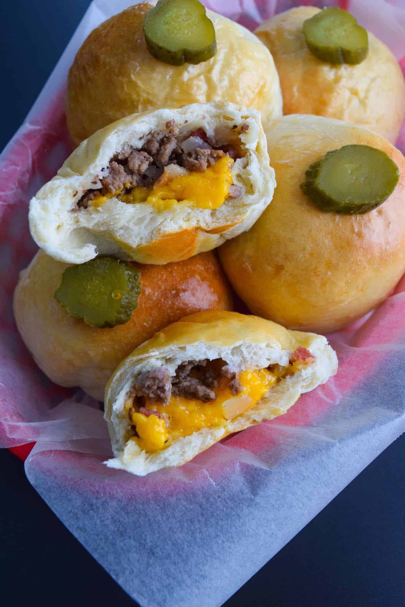 Bacon Cheeseburger Bombs cut in half to show cheesy inside close up view