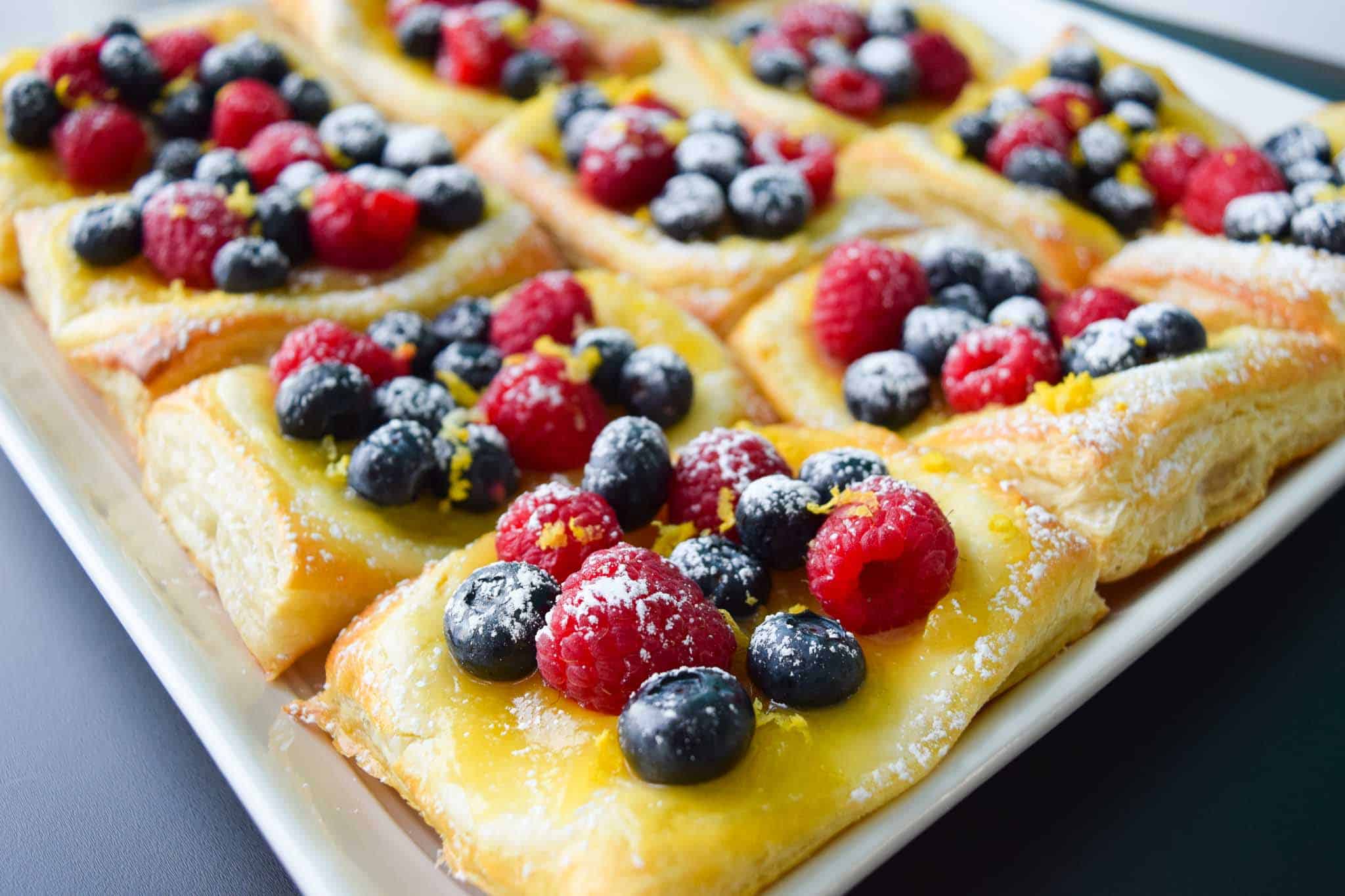 Lemon and Berry Cheesecake Puff on serving tray side view