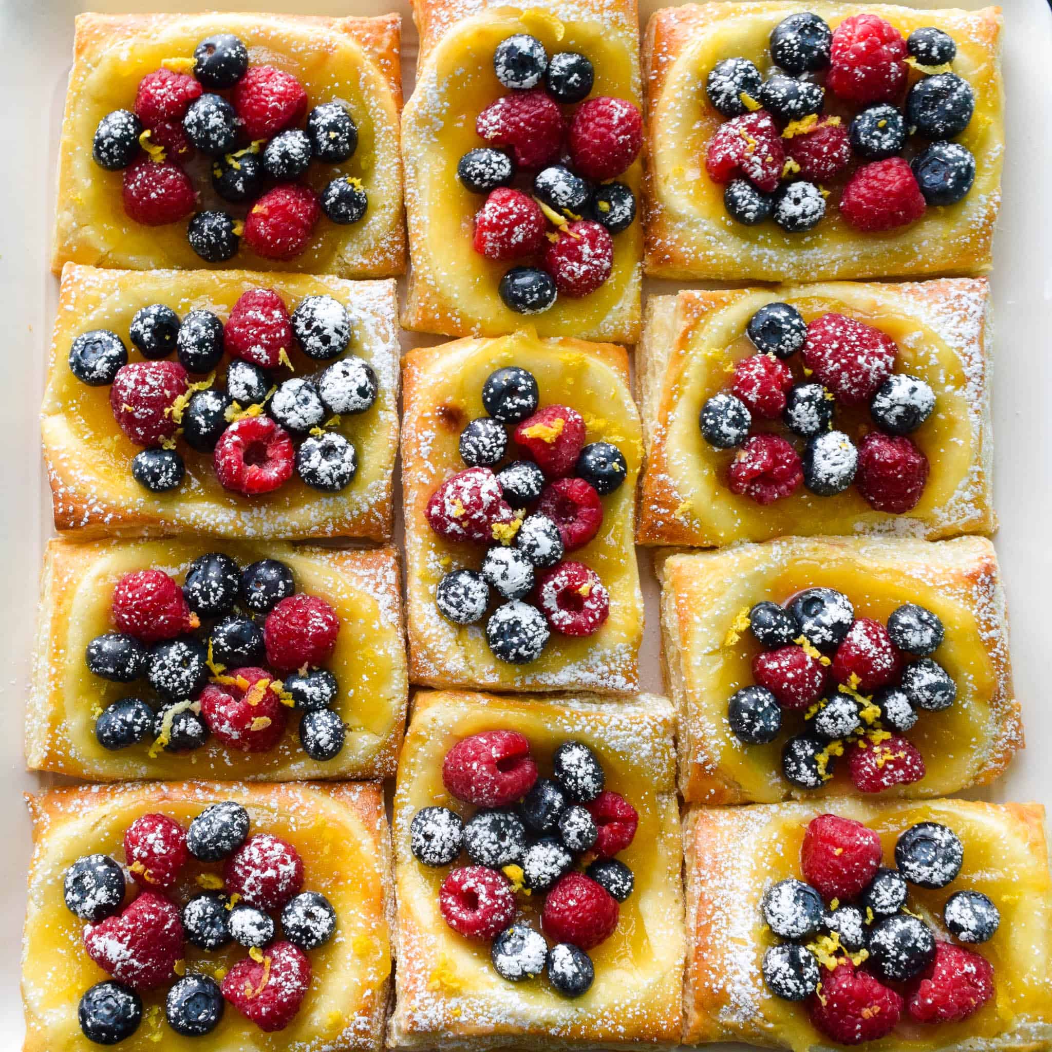 Lemon and Berry Cheesecake Puffs on serving tray overhead shot