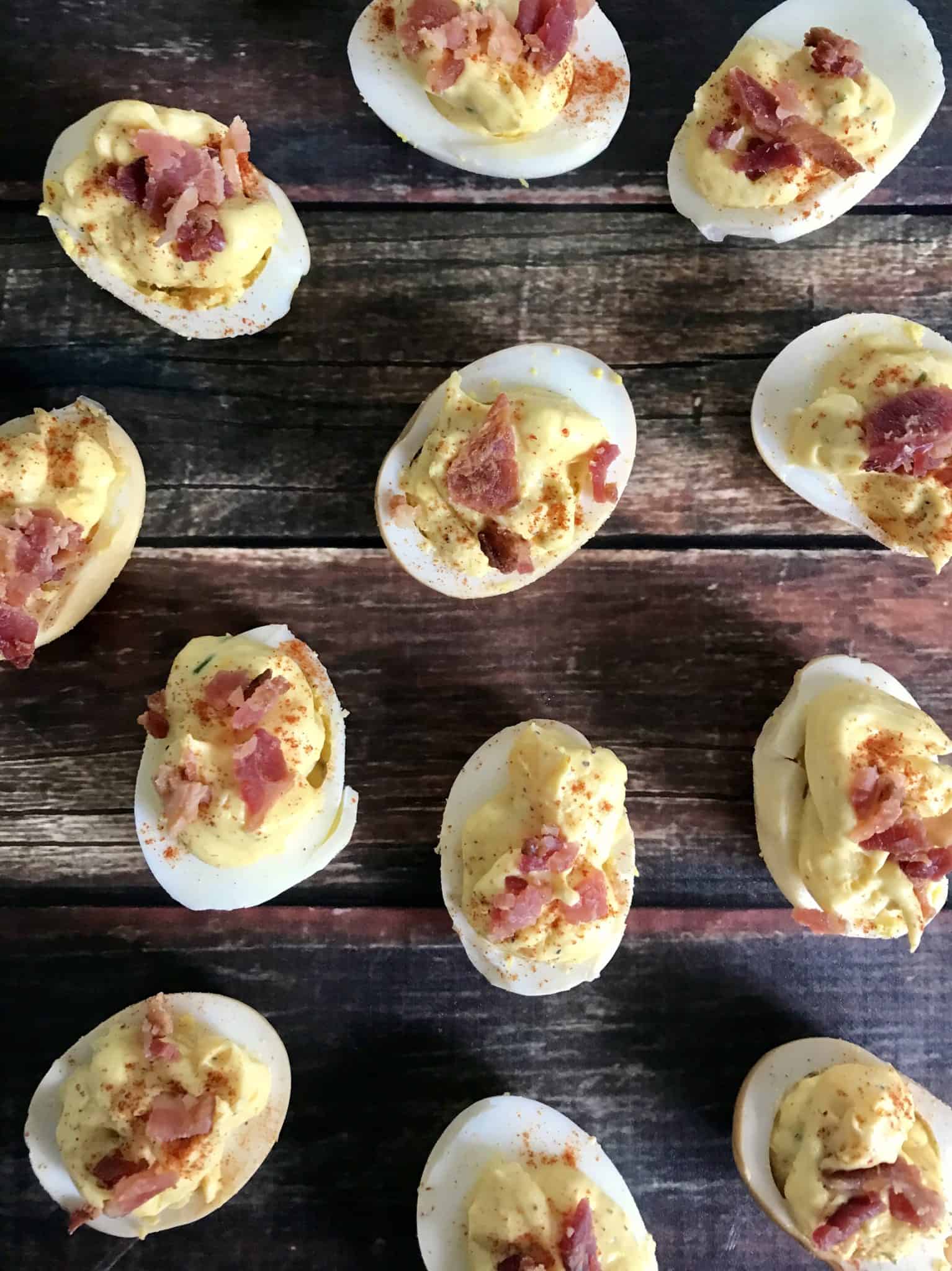 Smoked Deviled Eggs overhead shot on wood background 