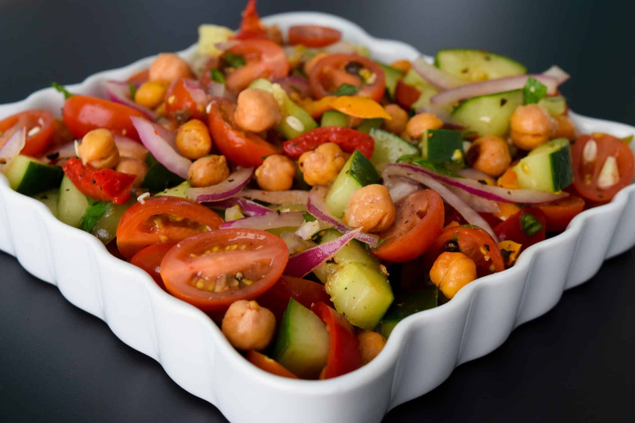 Roasted Chickpea Panzanella Salad in white serving tray close up view