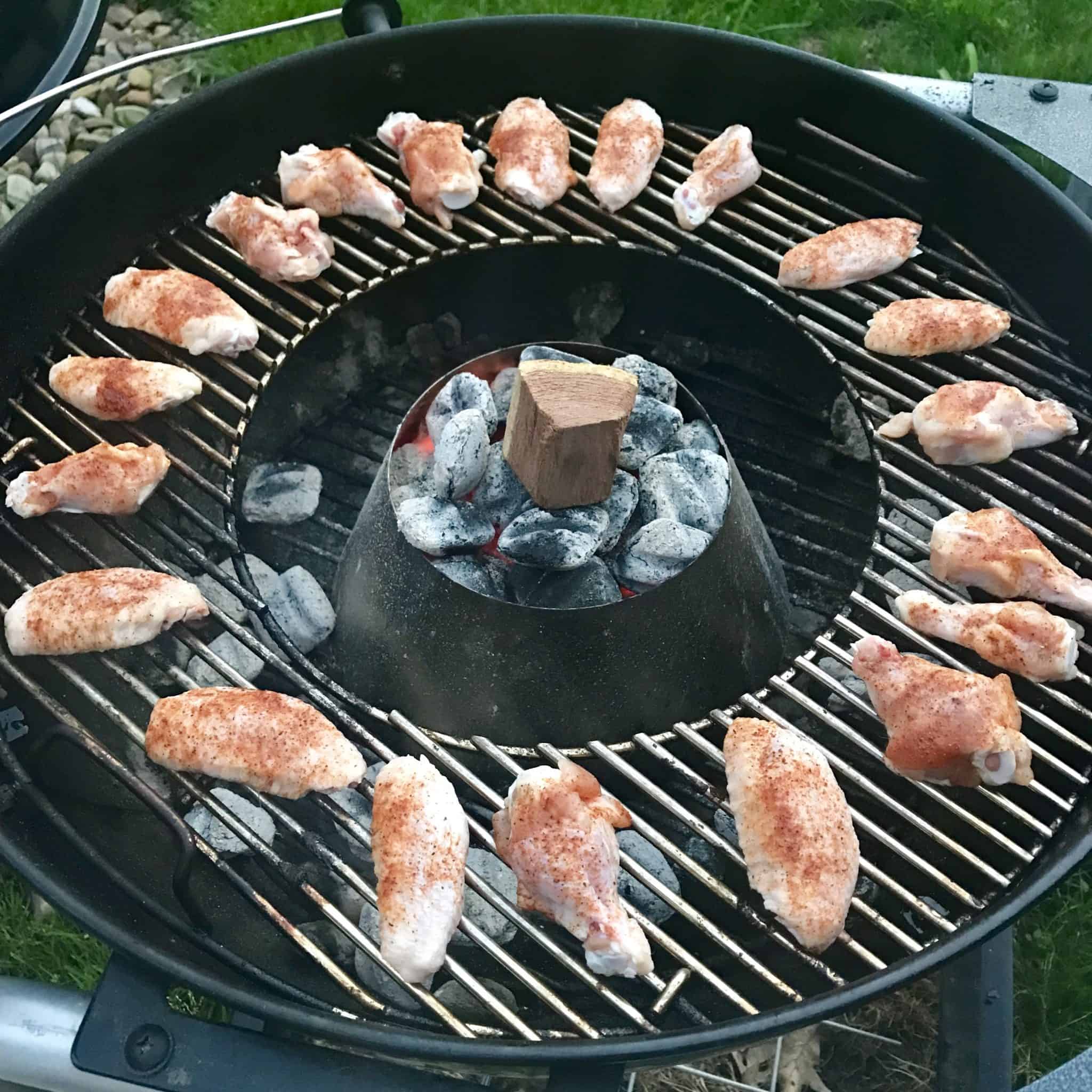 Chicken wings arranged in organized circle on weber grill with vortex in center