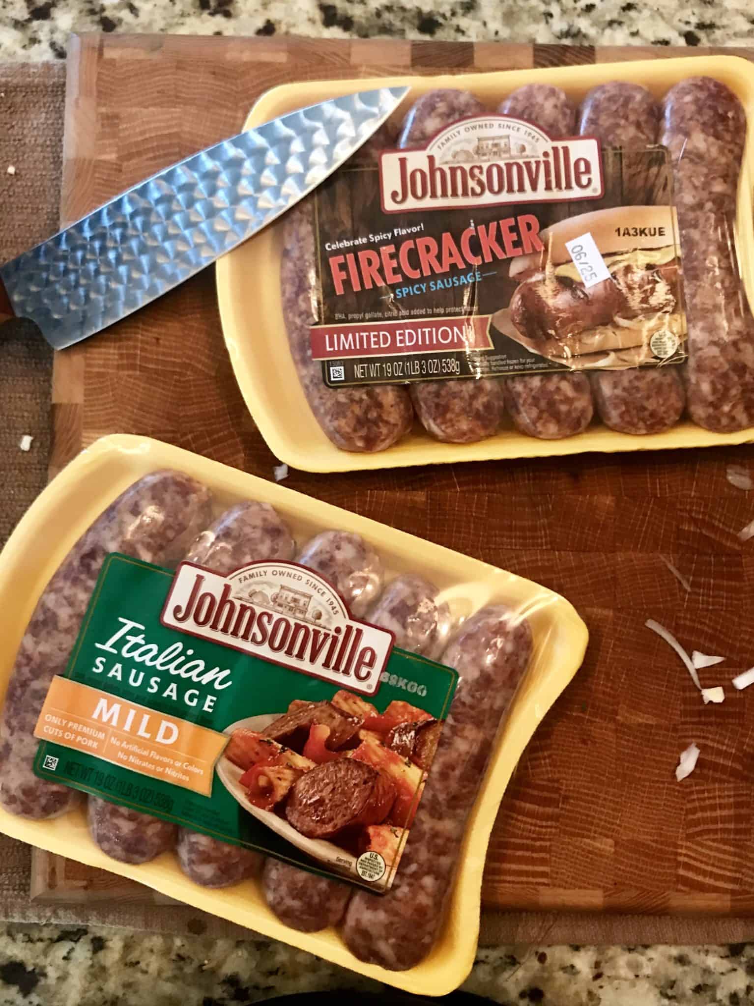 Johnsonville firecracker and mild Italian sausage packs on wooden cutting board overhead shot