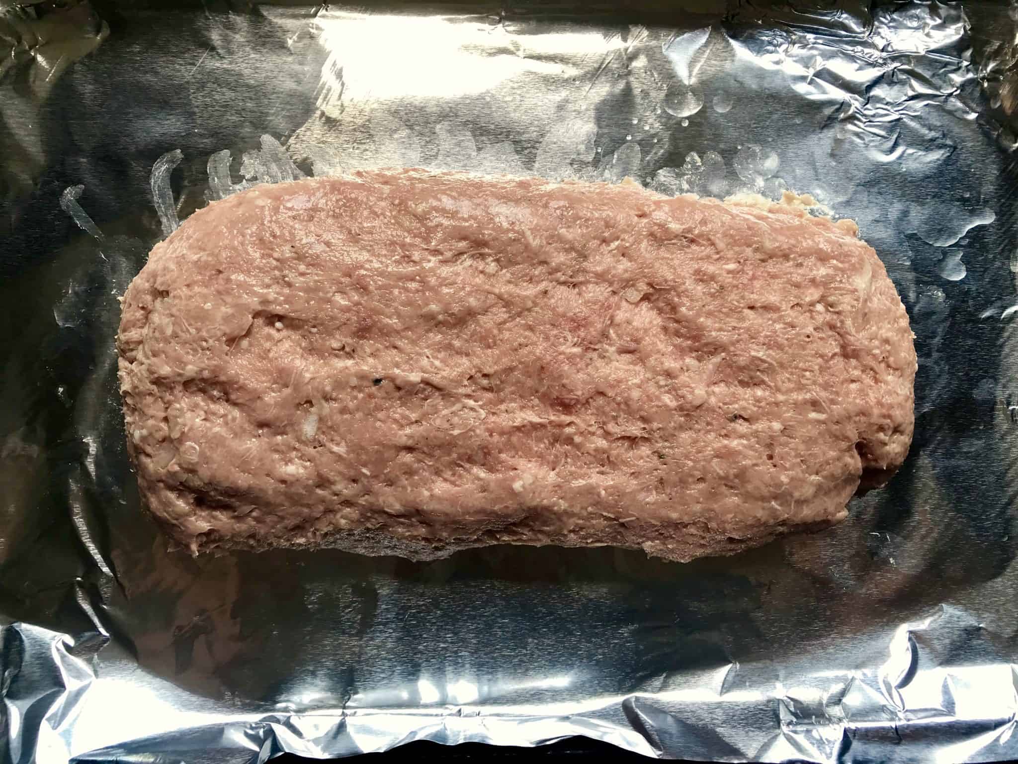 Gyro Meat formed into loaf on baking sheet reading to be cooked