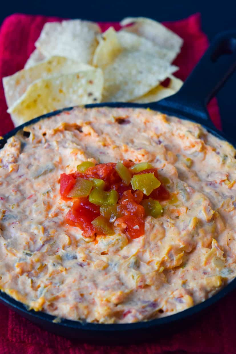 Skinny Queso Dip topped with red and green peppers close up view from side 