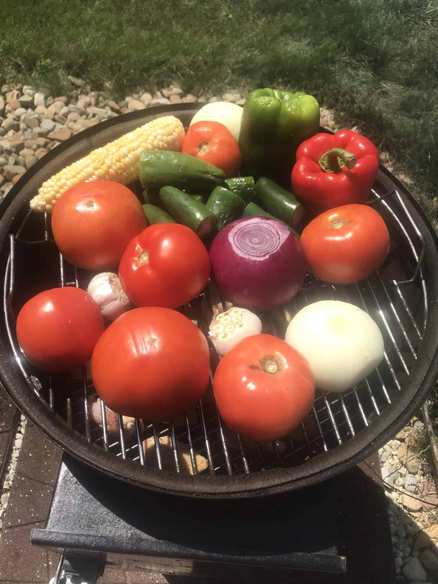 Fresh vegetables for smoked salsa on weber grill overhead shot