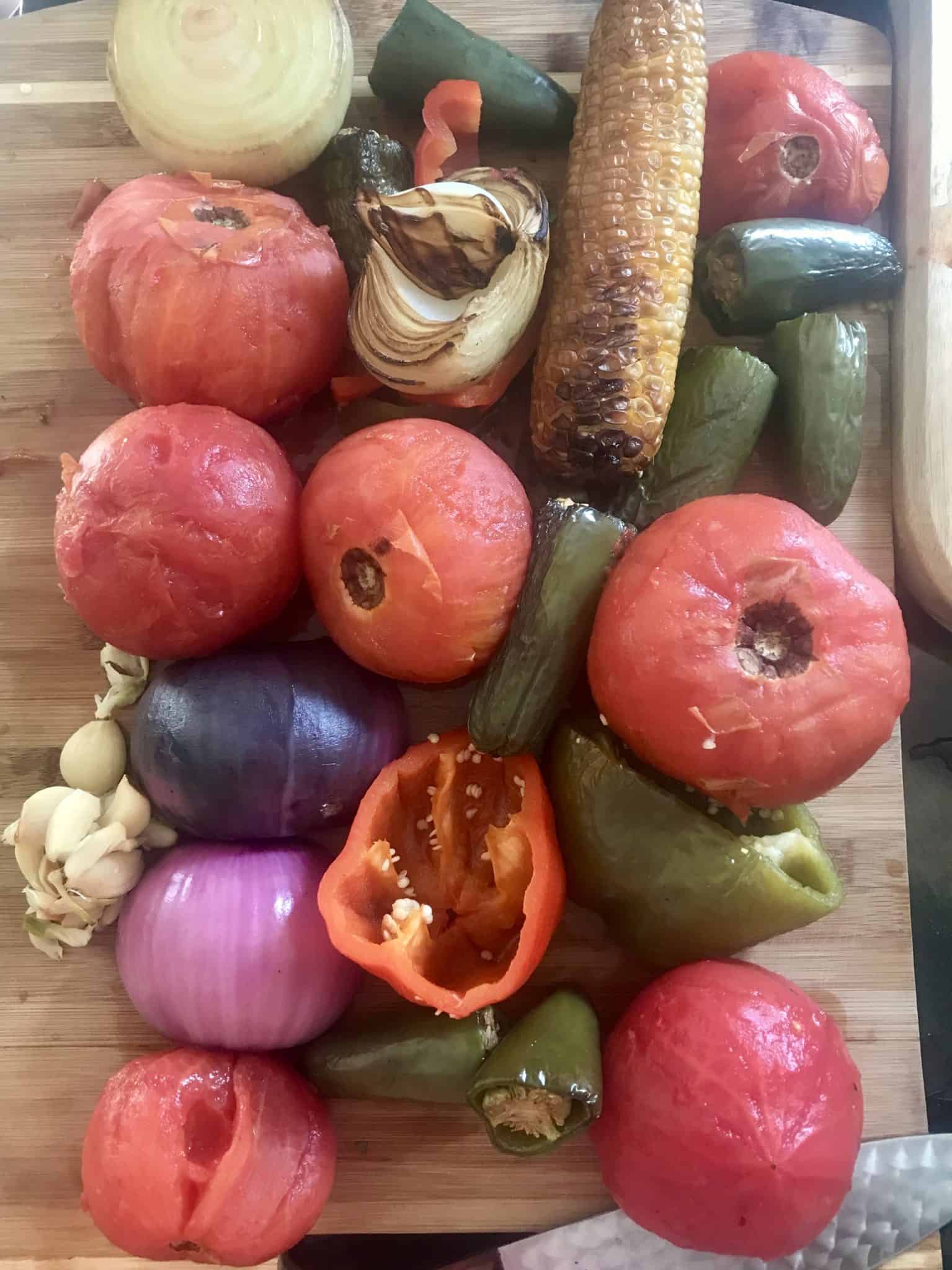 Smoked vegetables on wooden cutting board overhead shot