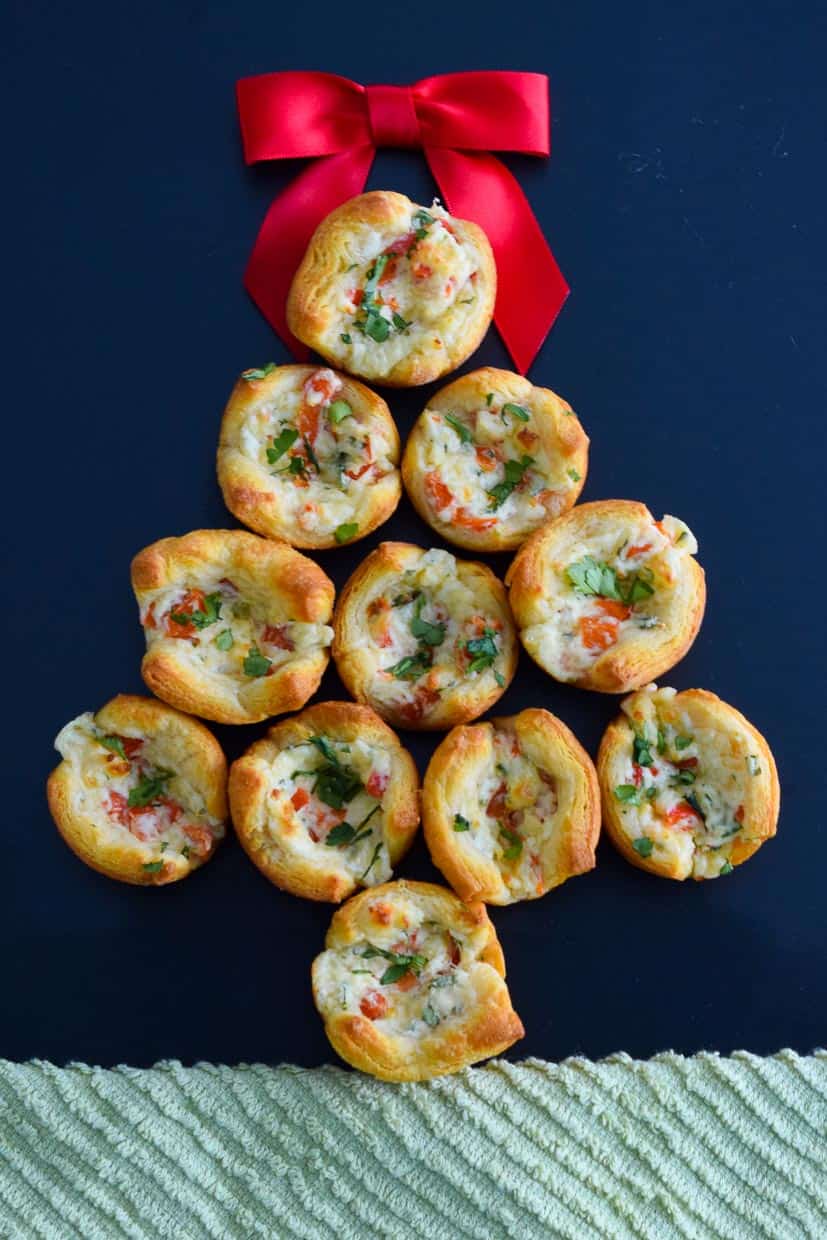 Easy Parmesan Pepper Puffs placed in shape of Christmas tree with red bow on top overhead shot