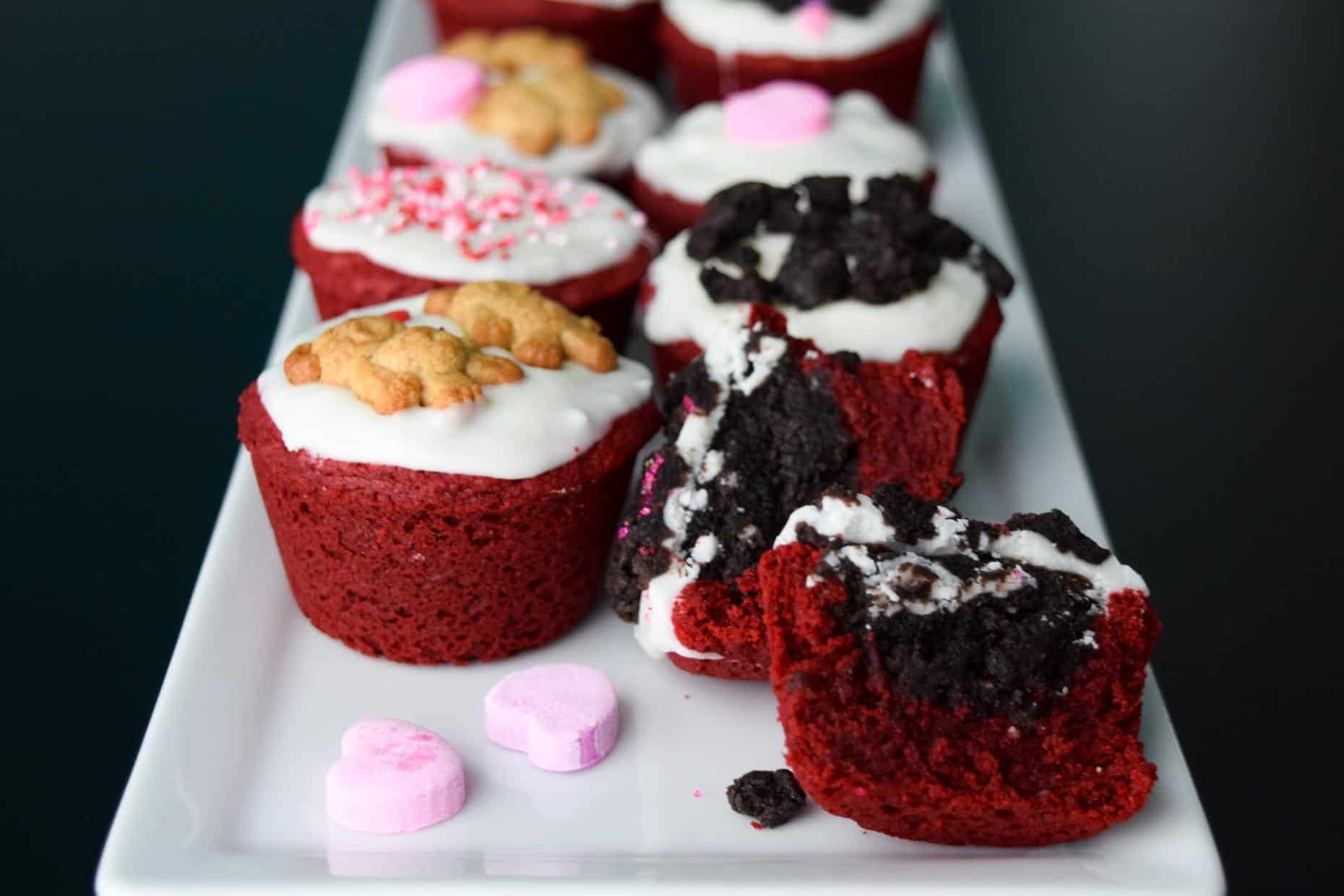 Red Velvet Oreo Valentine Cups on white platter with conversation hearts close up view