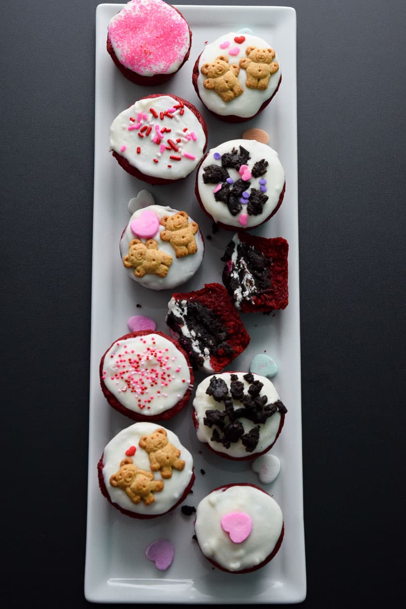 Red Velvet Oreo Valentine Cups on white platter with conversation hearts overhead shot