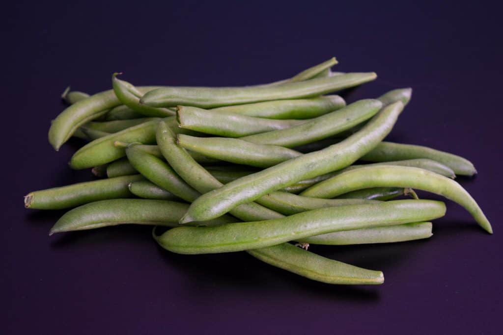 green beans on black background 