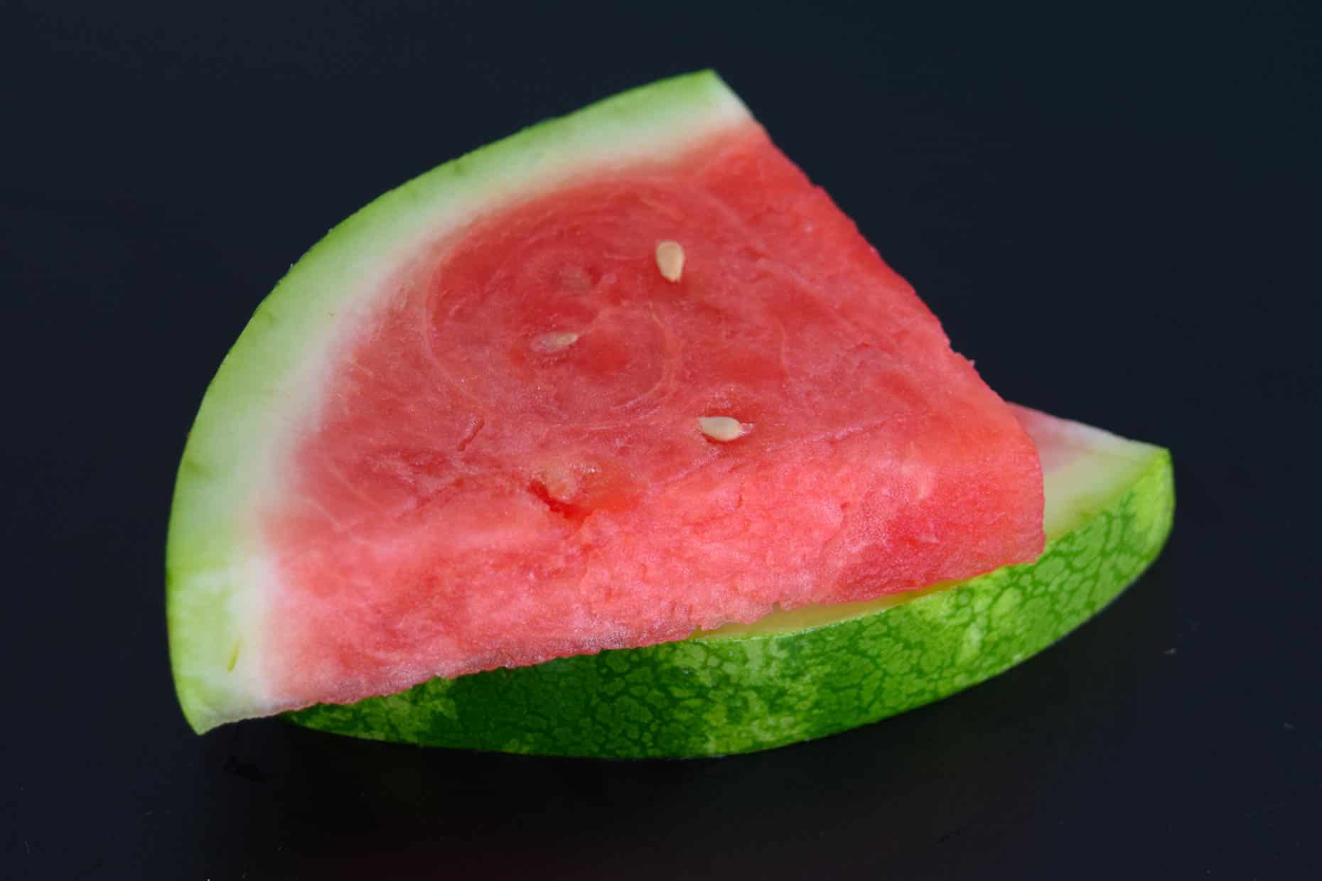 Watermelon slices on black background