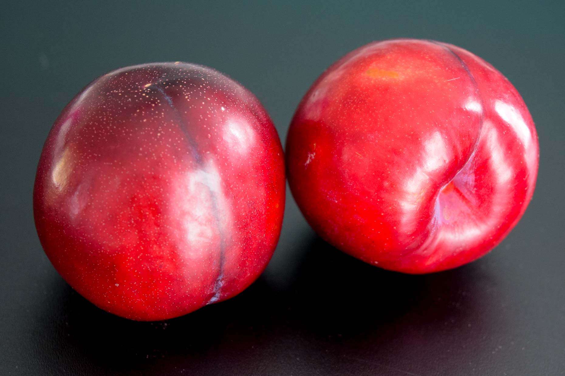 Plums on black background 