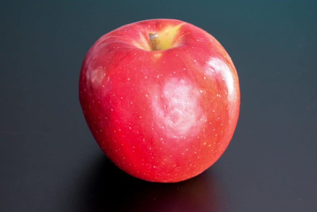 a red apple on a black background