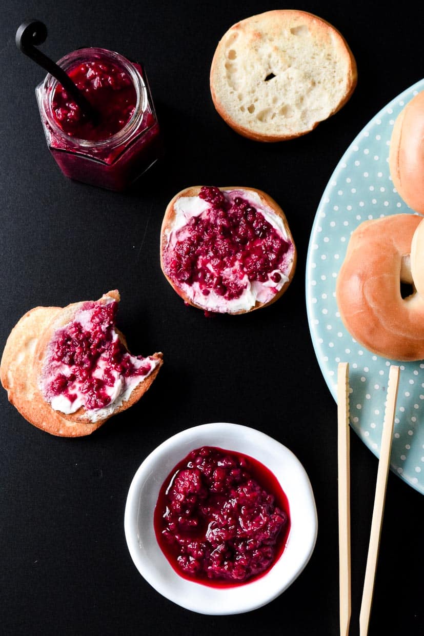 Fresh Mixed Berry Compote top view in white bowl with mini bagels topped with compote 