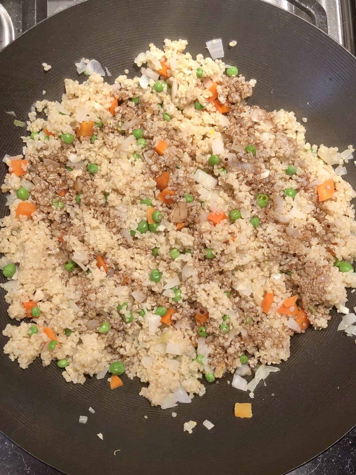 soy sauce drizzled over quinoa fried rice