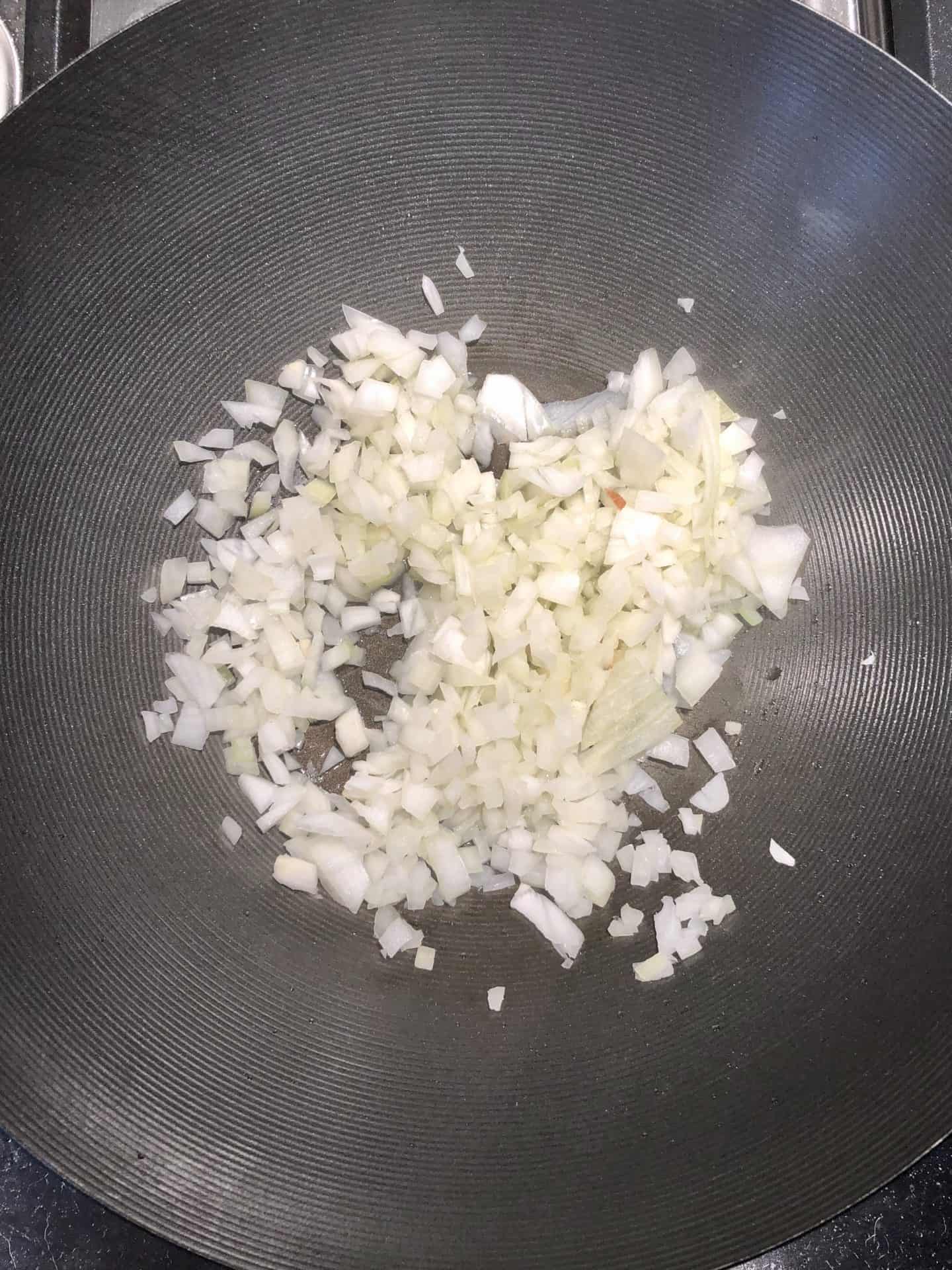 onions in wok pan