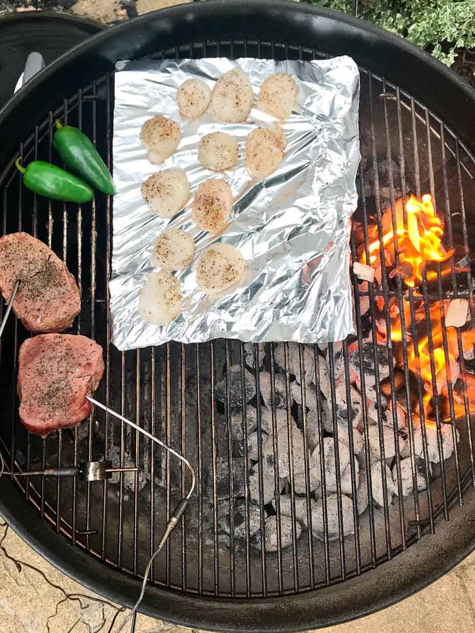 Scallops with steak and jalapeños on weber grill with flame over indirect heat