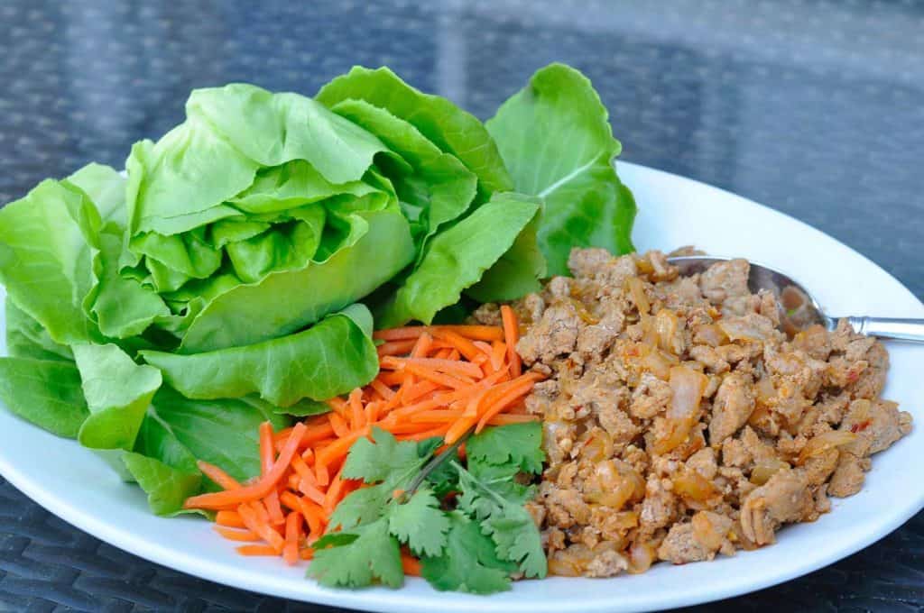 Lettuce wrap ingredients on white plate