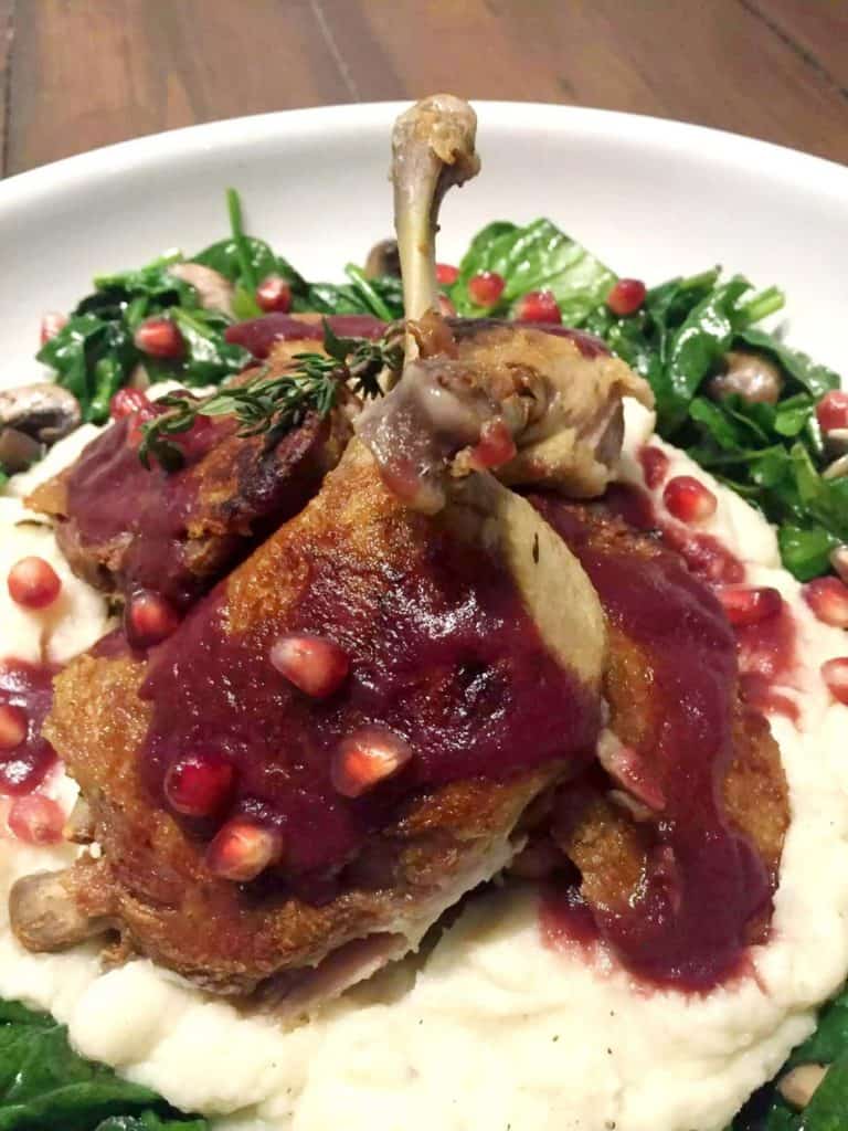 duck confit on white plate