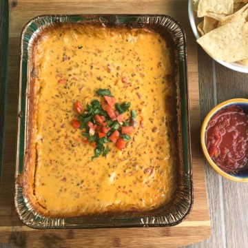 Smoked queso dip topped with cilantro and diced tomato overhead shot