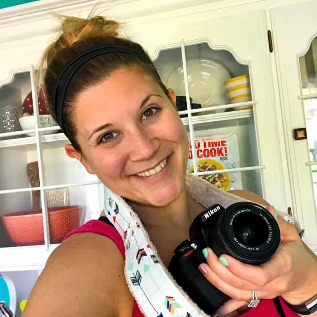 Image of Caitlin holding a Nikon camera