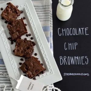 Chocolate chip brownies served on white platter with title written on black background
