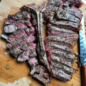 Sliced steak on cutting board overhead shot