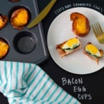 Bacon Egg Cups served on white plate with title written on black on chalkboard overhead shot