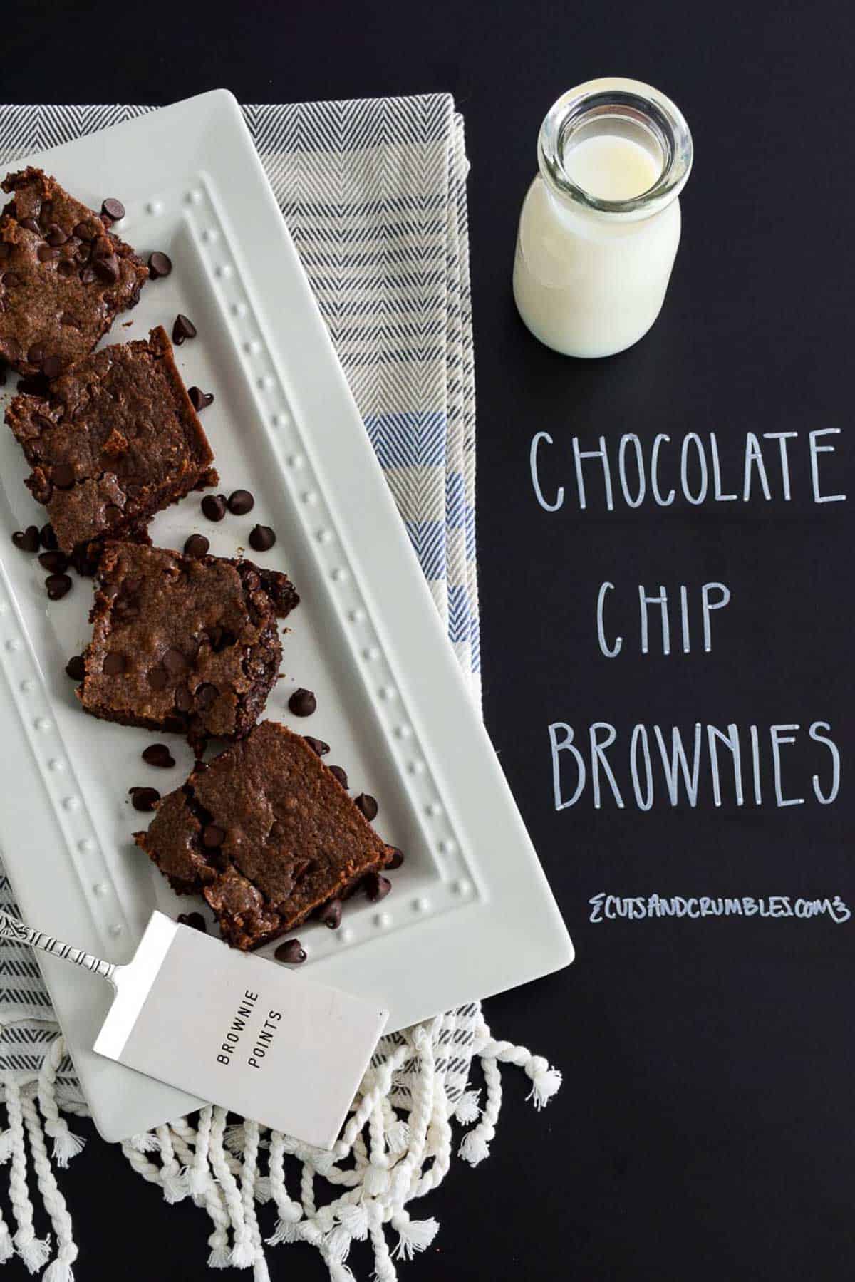 Chocolate Chip Brownies on white platter with title written on chalkboard